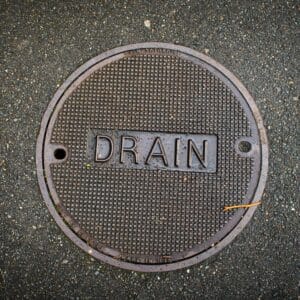 A drain cover set in concrete