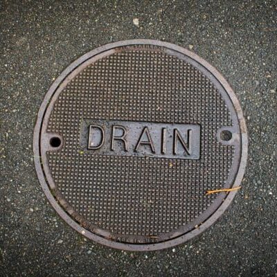 A drain cover set in concrete